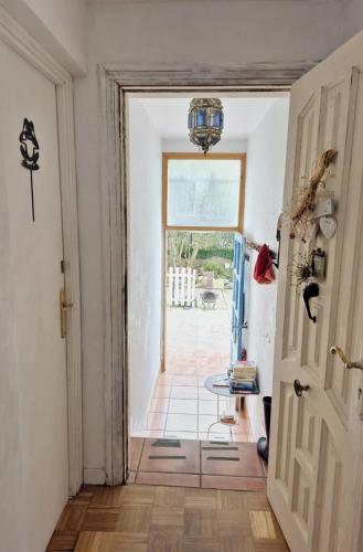 a hallway with a door and a table in a room at Quiet basic room in hosts house ideal for bikes and walking the camino in Zizur Mayor