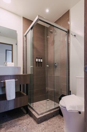 a bathroom with a shower and a toilet at Stylish apartments by VIATO HOMES in Mexico City
