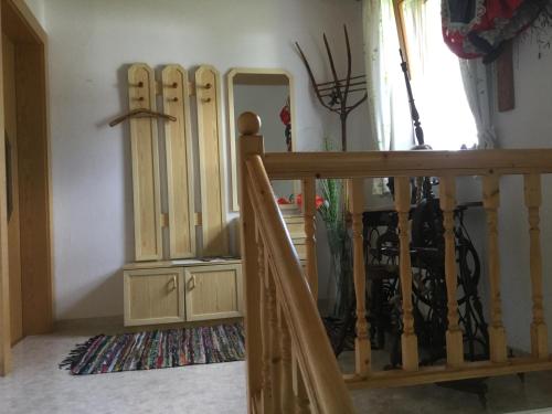 a room with wooden cabinets and a staircase with a mirror at Ferienhaus Andrä in Hermagor