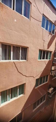 a building with several windows on the side of it at Hotel Kolman in Capão da Canoa