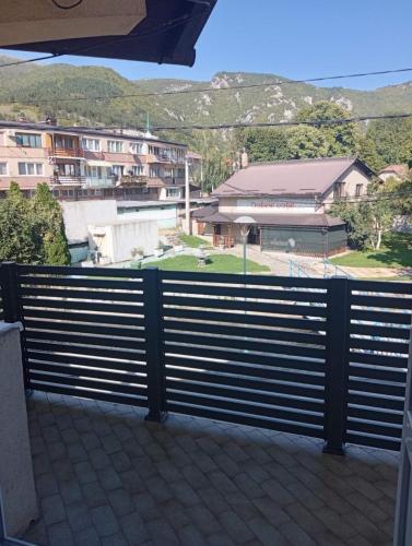 a balcony with a fence with a view of buildings at Apartman Travnik in Travnik