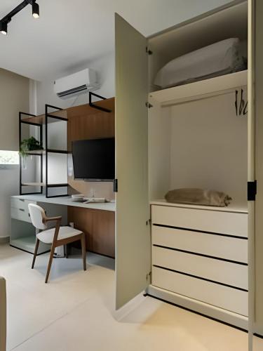 a bedroom with a bunk bed and a desk at Studio Luggo Pampulha in Belo Horizonte