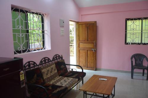 a living room with a couch and a table at ChillOuts Morjim in Morjim