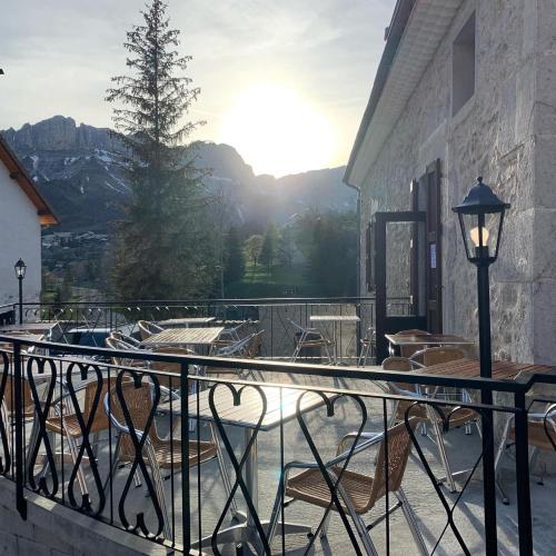 a balcony with chairs and a view of a mountain at La Chicholiere in Gresse-en-Vercors