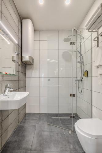 a bathroom with a glass shower and a sink at Bukovel Hotel in Bukovel