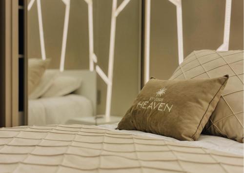 a bed with a pillow on top of it at Studios Heaven in Gramado