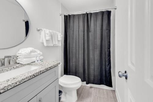 a white bathroom with a toilet and a sink at SHV A3: The Crestwind in Myrtle Beach
