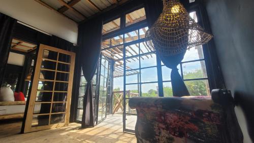a living room with a couch and a chandelier at DesertDewEstate in Nanyuki