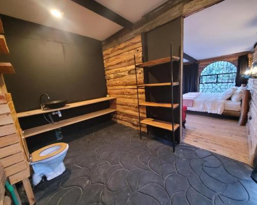 a bathroom with a bed and a toilet in a room at DesertDewEstate in Nanyuki