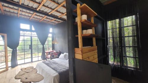 a bedroom with a bed in a room with windows at DesertDewEstate in Nanyuki