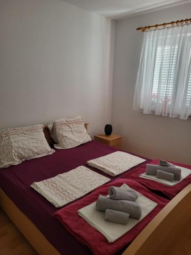 a bedroom with a bed with towels on it at Nina in Karigador