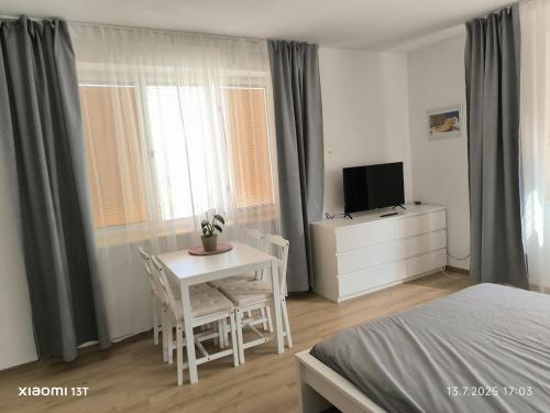 a bedroom with a bed and a table and a television at Modern comfort in the heart of the city of Dvůr Králové nad Labem in Dvůr Králové nad Labem