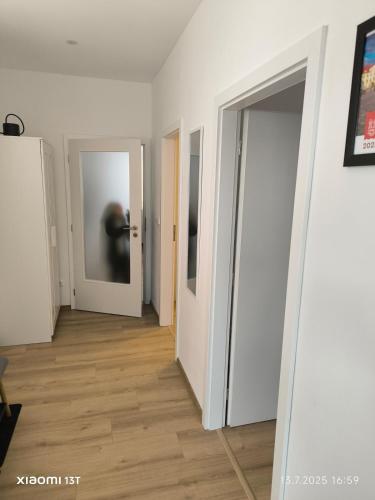 a hallway with white walls and two doors at Modern comfort in the heart of the city of Dvůr Králové nad Labem in Dvůr Králové nad Labem