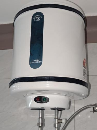 a close up of a white toaster with a black object at Serene villas in Kitala