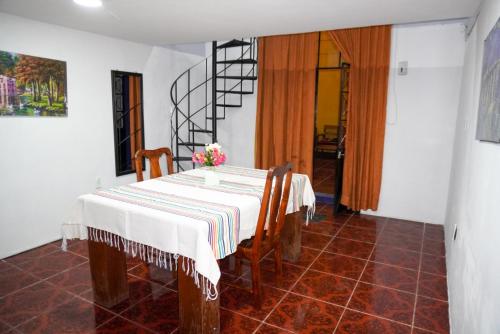 a dining room with a table and chairs and a staircase at Hostal puebla in San Baltasar