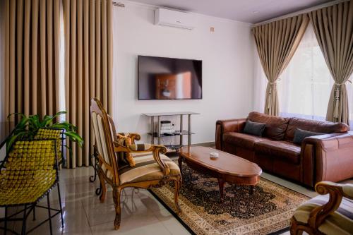 a living room with a couch and a table at Villa Stone Apartments in Lusaka