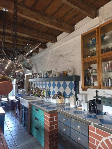 a kitchen with blue cabinets and a counter top at Ferienhaus Siegstrand in Mittelhof