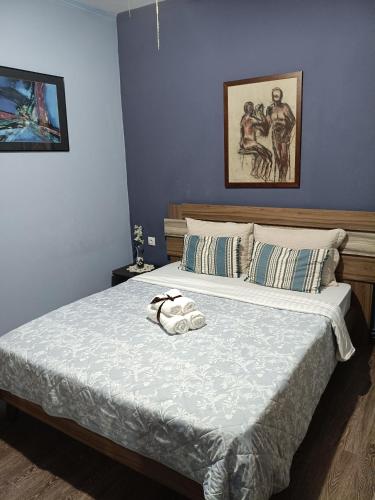 Ένα ή περισσότερα κρεβάτια σε δωμάτιο στο Casa Rita ΛΟΥΤΡΑ ΠΟΖΑΡ