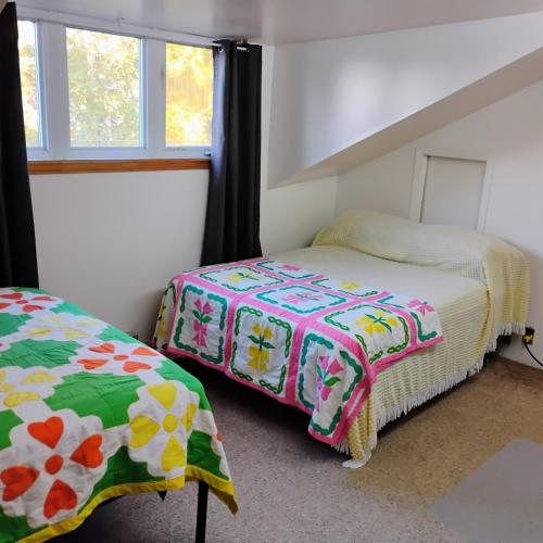 a bedroom with two beds and a window at 6 Olivia Lane in Deer Lake
