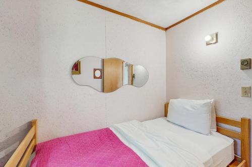 a small bedroom with a bed and a mirror at Ahmeek Retreat in Podunk