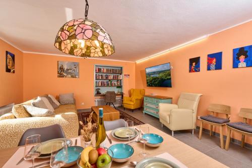 a living room with a couch and a table with fruits on it at Eifelgold Ferienwohnung in Daun