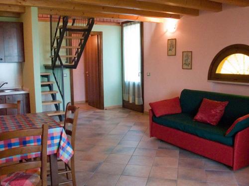 a living room with a green couch and a table at B&B Borgo Tre Case in Cavriana