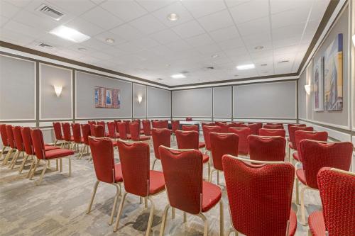 a conference room with red chairs and a table at Best Western Royal Plaza Hotel and Trade Center in Marlborough