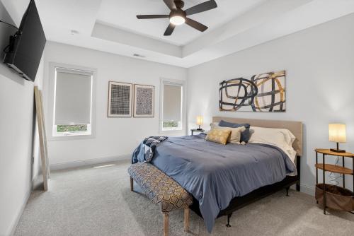 a bedroom with a bed and a ceiling fan at Plush & Roomy - Perfect for All Ages near KU & KC Duplex in Lawrence