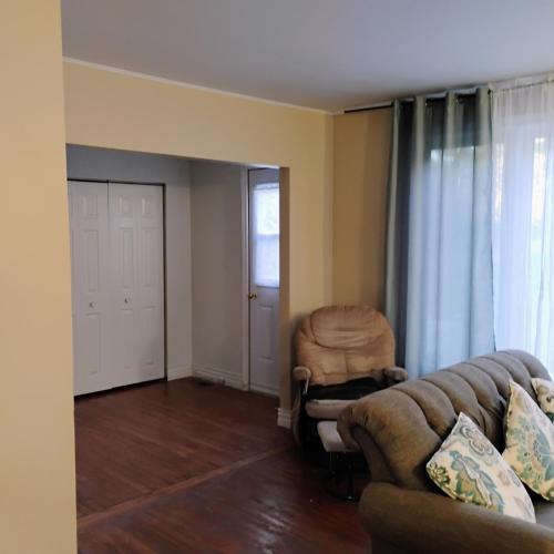 a living room with a couch and a chair at 6 Olivia Lane in Deer Lake