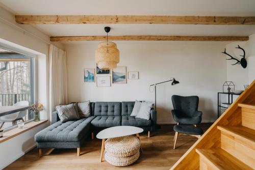 a living room with a couch and two chairs at Chata u Jezera Holany in Holany