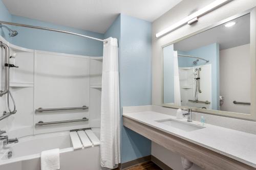 a bathroom with two sinks and a mirror at WoodSpring Suites Savannah West - Ellabell Metaplant in Ellabell
