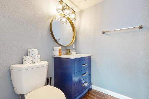 a bathroom with a white toilet and a mirror at Glendale Groovin' in Glendale
