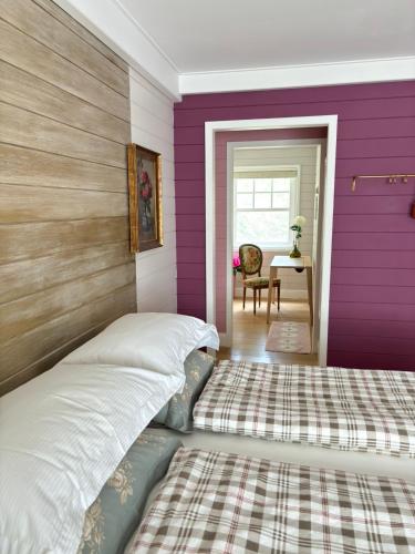 a bedroom with purple and white walls and a bed at A Calm & Quiet Stay in Wuustwezel