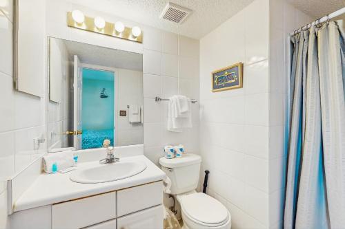 a white bathroom with a sink and a toilet at Ocean House I 1702 in Gulf Shores