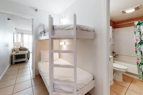a bathroom with bunk beds in a room with a toilet at Emerald Skye 42 in Orange Beach