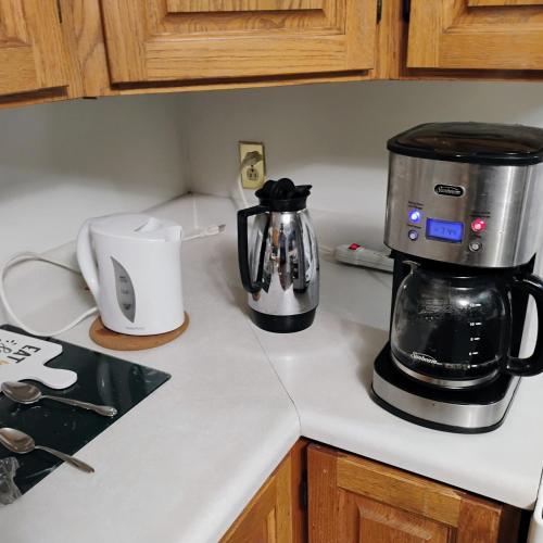 a coffeemaker and a coffee maker on a kitchen counter at 6 Olivia Lane in Deer Lake