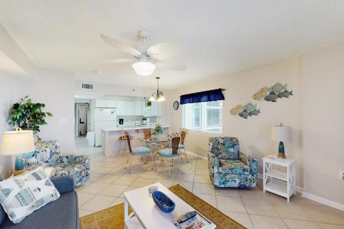 a living room with a couch and chairs and a table at Four Winds 701 in Romar Beach