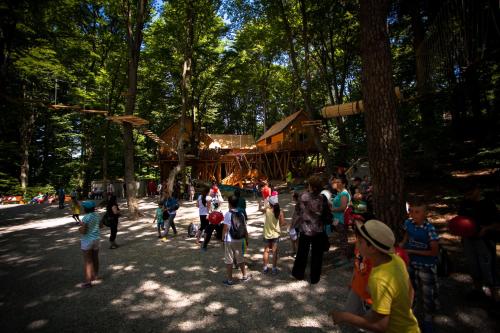 a group of people standing in front of a playground at Lux Garden Hotel in Azuga