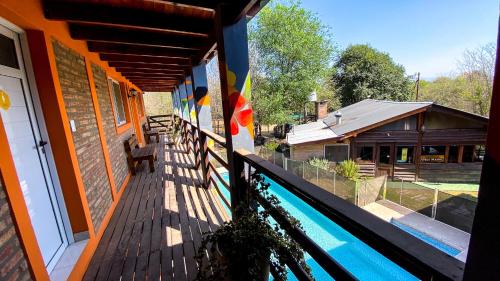 a balcony of a house with a swimming pool at Eirú Hostel in Santa Rosa de Calamuchita