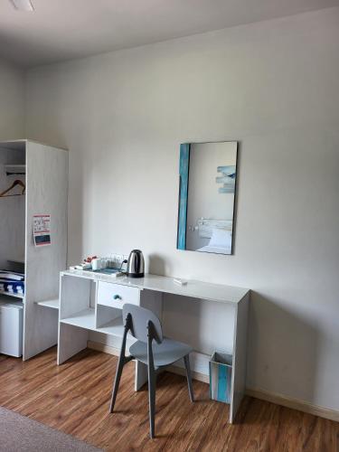a white desk with a chair and a mirror at Ocean Pearl in Gulhi