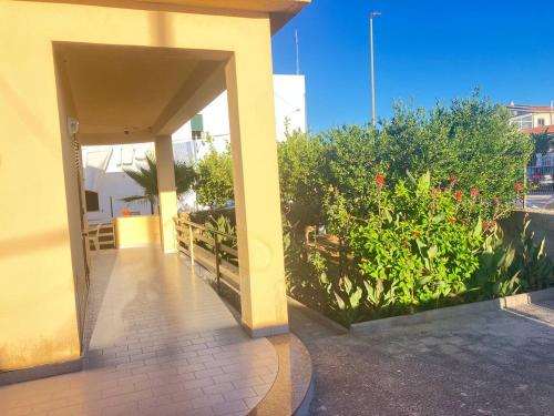 an open hallway of a building with flowers and plants at AleMar House in Marinella di Selinunte