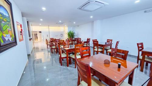a dining room with wooden tables and chairs at Hotel VILLA CABAÑA in Villagarzón