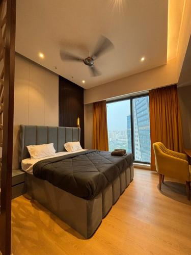 a bedroom with a bed and a ceiling fan at Sun n Sapphire - Book Half Day or Night in Ghaziabad