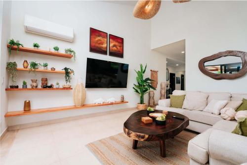 a living room with a couch and a table at Super Private Beachfront 3BR Villa & Infinity Pool in La Garita