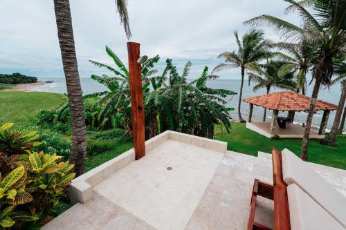 an outdoor patio with a view of the ocean at Super Private Beachfront 3BR Villa & Infinity Pool in La Garita