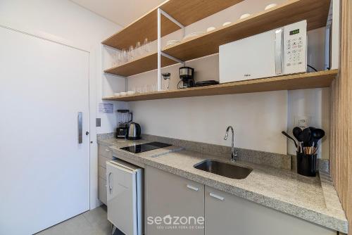 a kitchen with a sink and a counter top at MHFA - Studios em Prédio Luxuoso com Vista Mar in Itapema