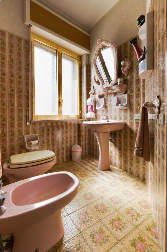 a bathroom with a sink and a toilet and a mirror at L'Onda in Marina di Ragusa
