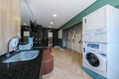 a laundry room with a washer and dryer at Luxurious condo | Budget flat in Sao Paulo