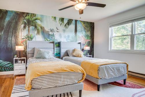 two beds in a bedroom with a tropical wallpaper at Golf, Hike and Explore Family Home in Pembroke! in Bow Center
