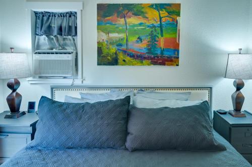 a bedroom with a bed with a painting on the wall at Shared Yard Apt 2 Mi to Port Angeles City Pier in Port Angeles